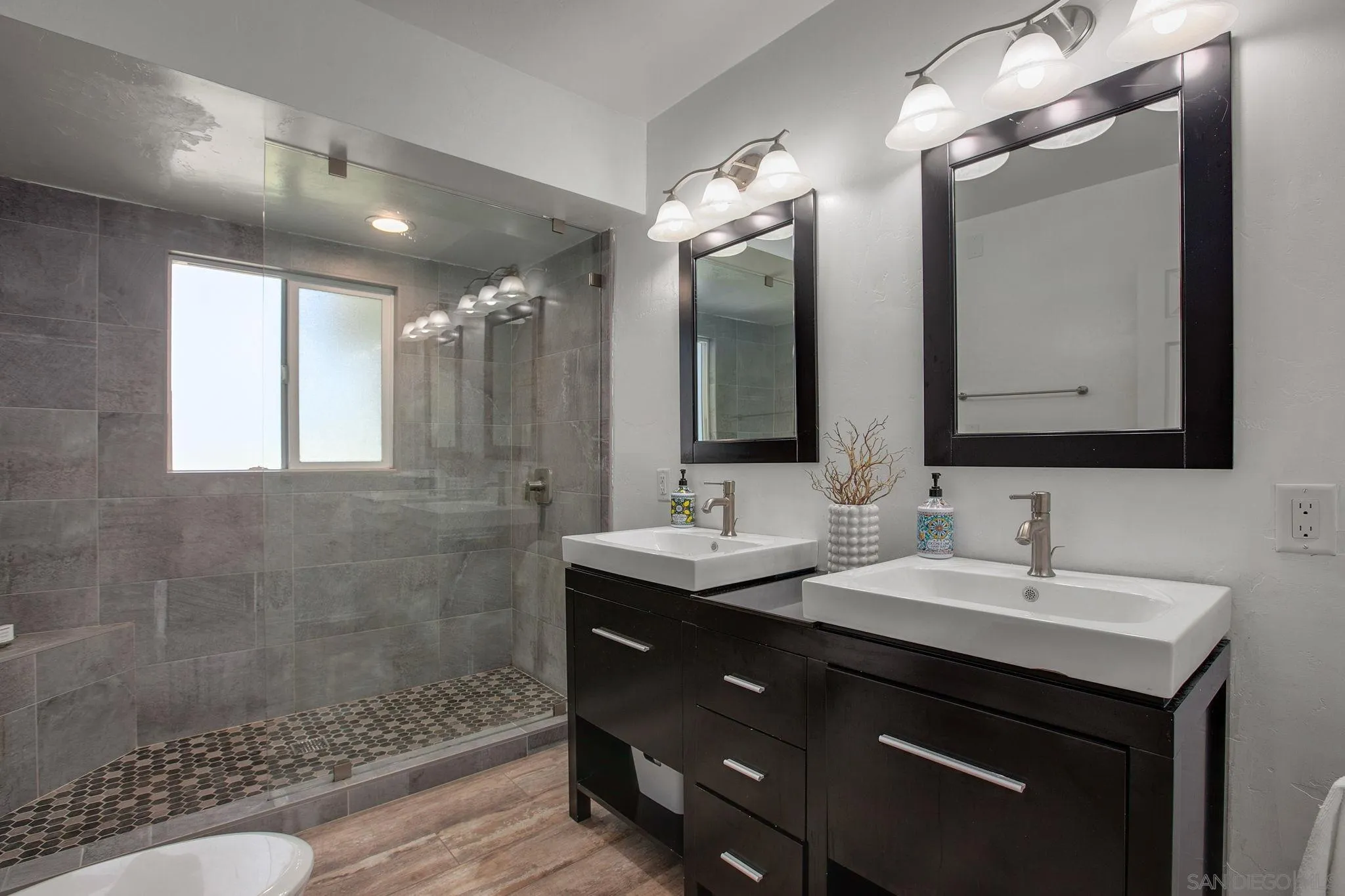 1625 Eolus Avenue Encinitas, CA 92024 - Photo 15 of 37 a bathroom with a double vanity sink mirror and shower
