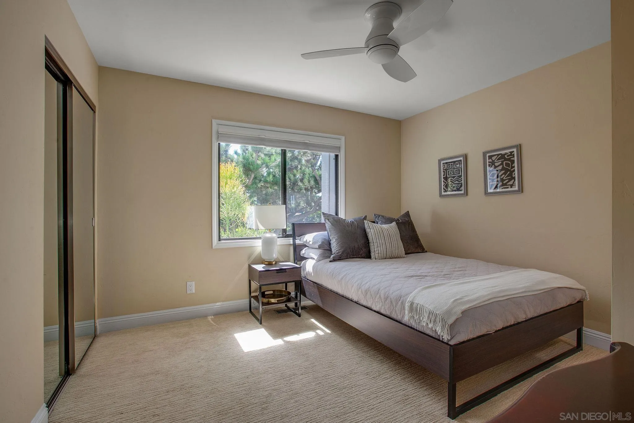 1625 Eolus Avenue Encinitas, CA 92024 - Photo 19 of 37 a bedroom with a bed lamp and a window