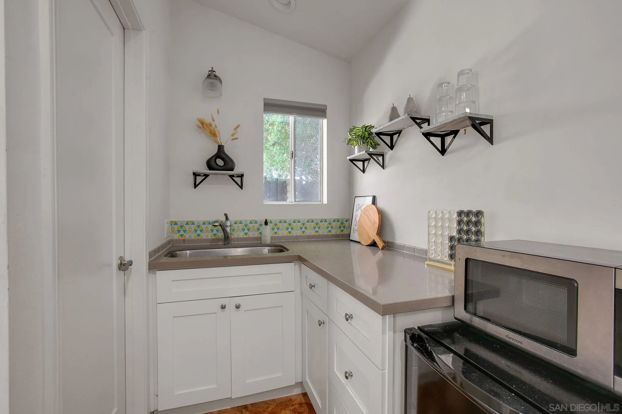 1625 Eolus Avenue Encinitas, CA 92024 - Photo 24 of 37 a kitchen with a sink and cabinets