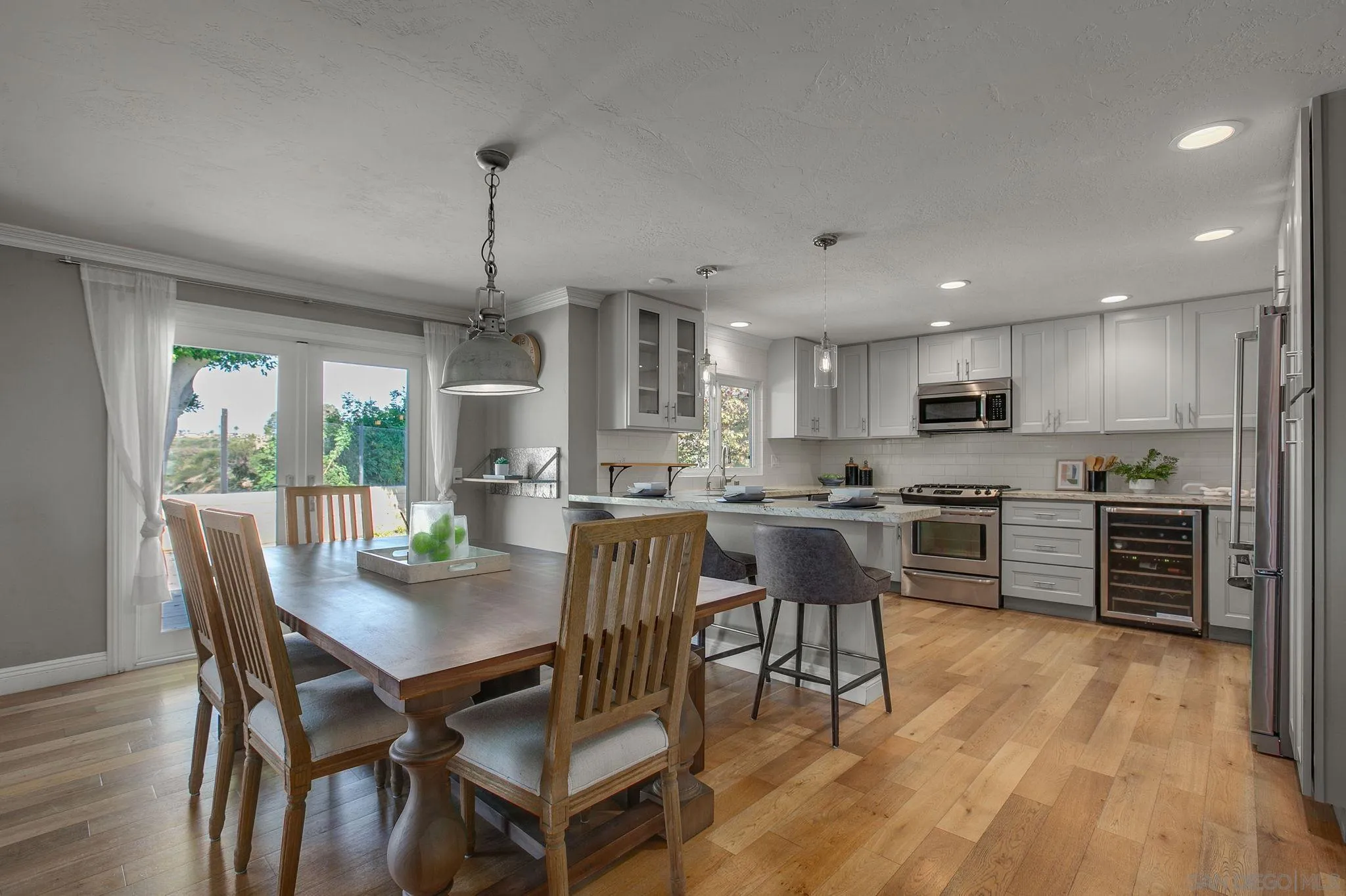 1625 Eolus Avenue Encinitas, CA 92024 - Photo 6 of 37 a kitchen with kitchen island a dining table and chairs