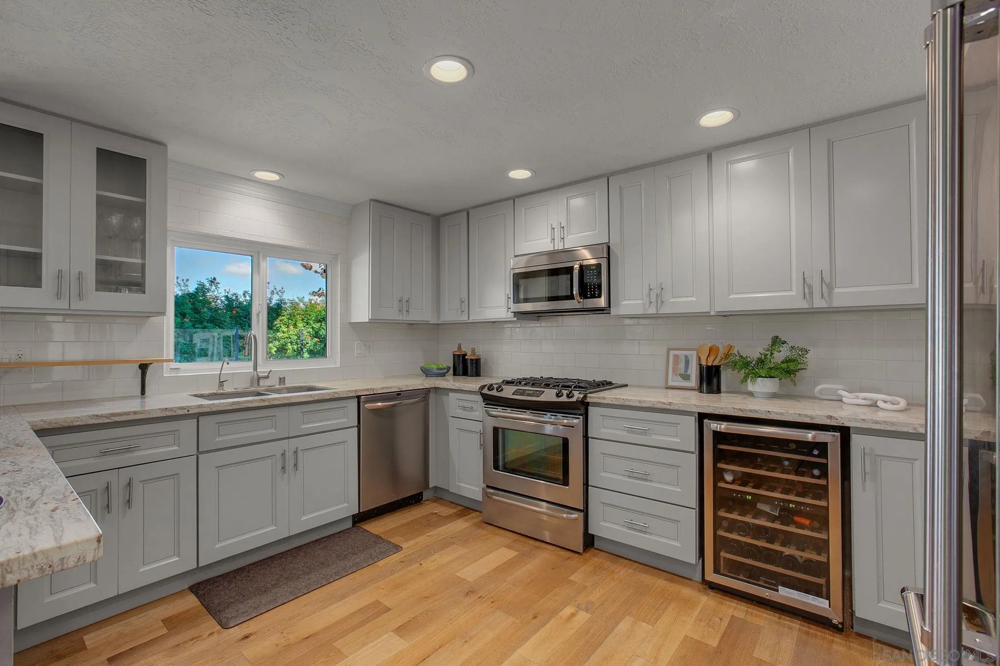 1625 Eolus Avenue Encinitas, CA 92024 - Photo 9 of 37 a kitchen with stainless steel appliances granite countertop a stove sink and cabinets