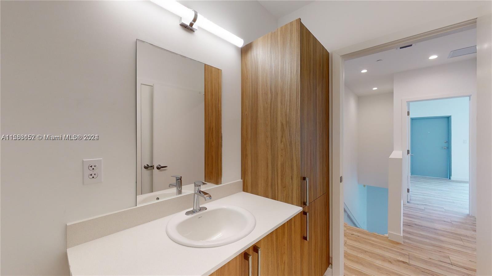 24705 Southwest 129th Avenue, Unit 109 Homestead, FL 33032 - Photo 11 of 22 a bathroom with a sink and a mirror