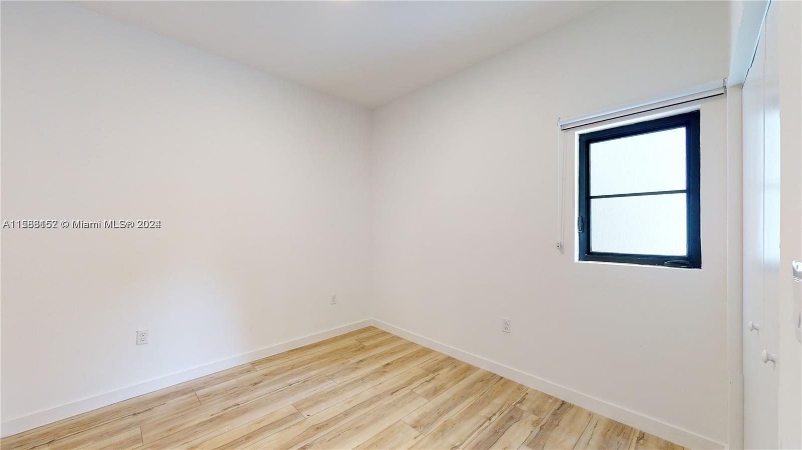 24705 Southwest 129th Avenue, Unit 109 Homestead, FL 33032 - Photo 13 of 22 a view of a small space with wooden floor and a window