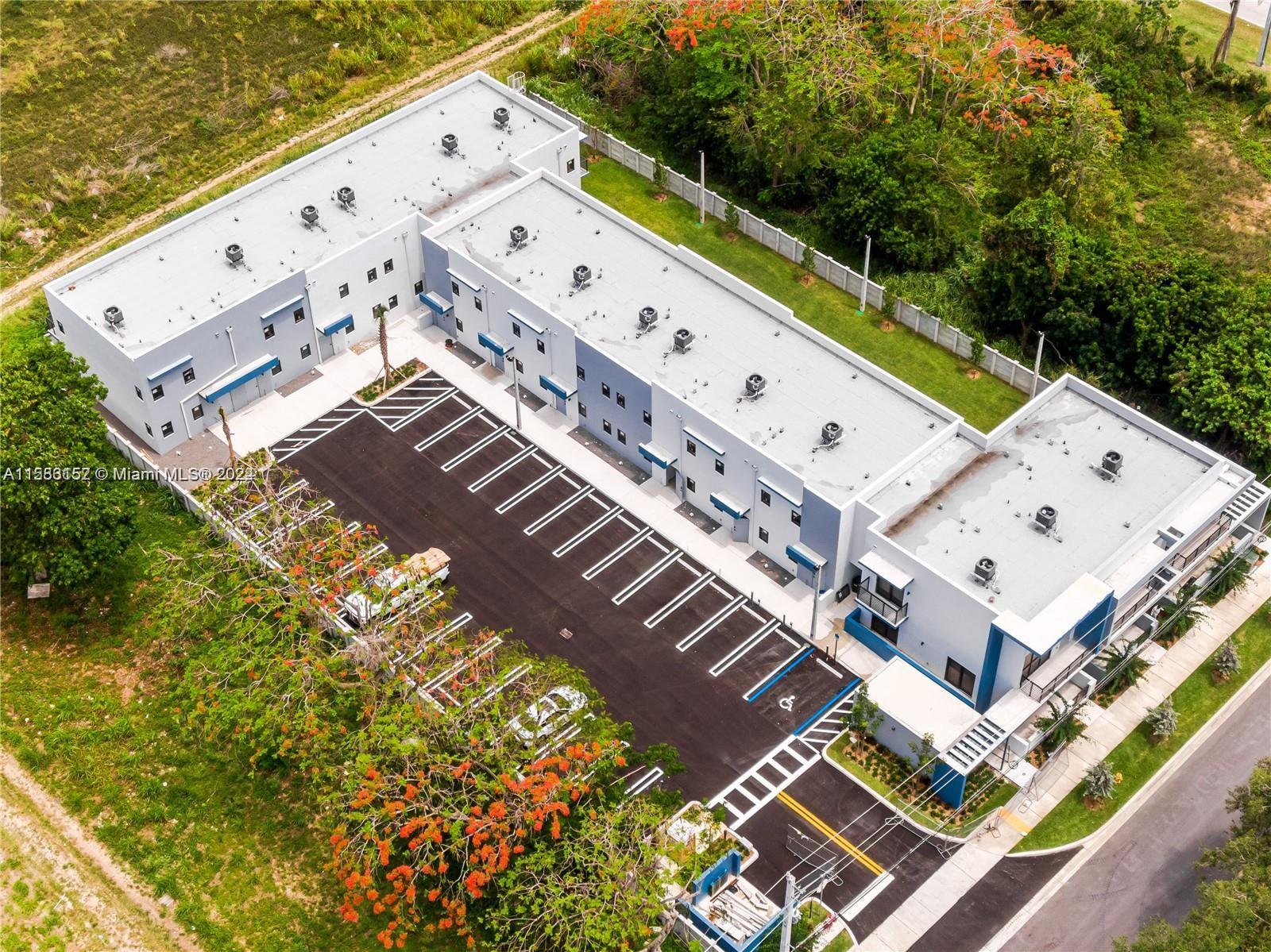 24705 Southwest 129th Avenue, Unit 109 Homestead, FL 33032 - Photo 22 of 22 a view of a building with a outdoor space