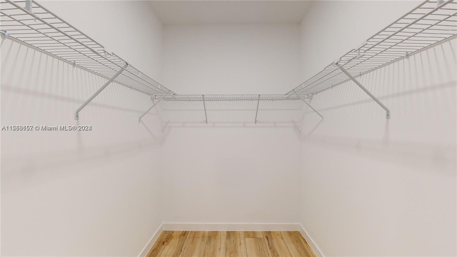 24705 Southwest 129th Avenue, Unit 109 Homestead, FL 33032 - Photo 9 of 22 a view of a room with racks on the wall