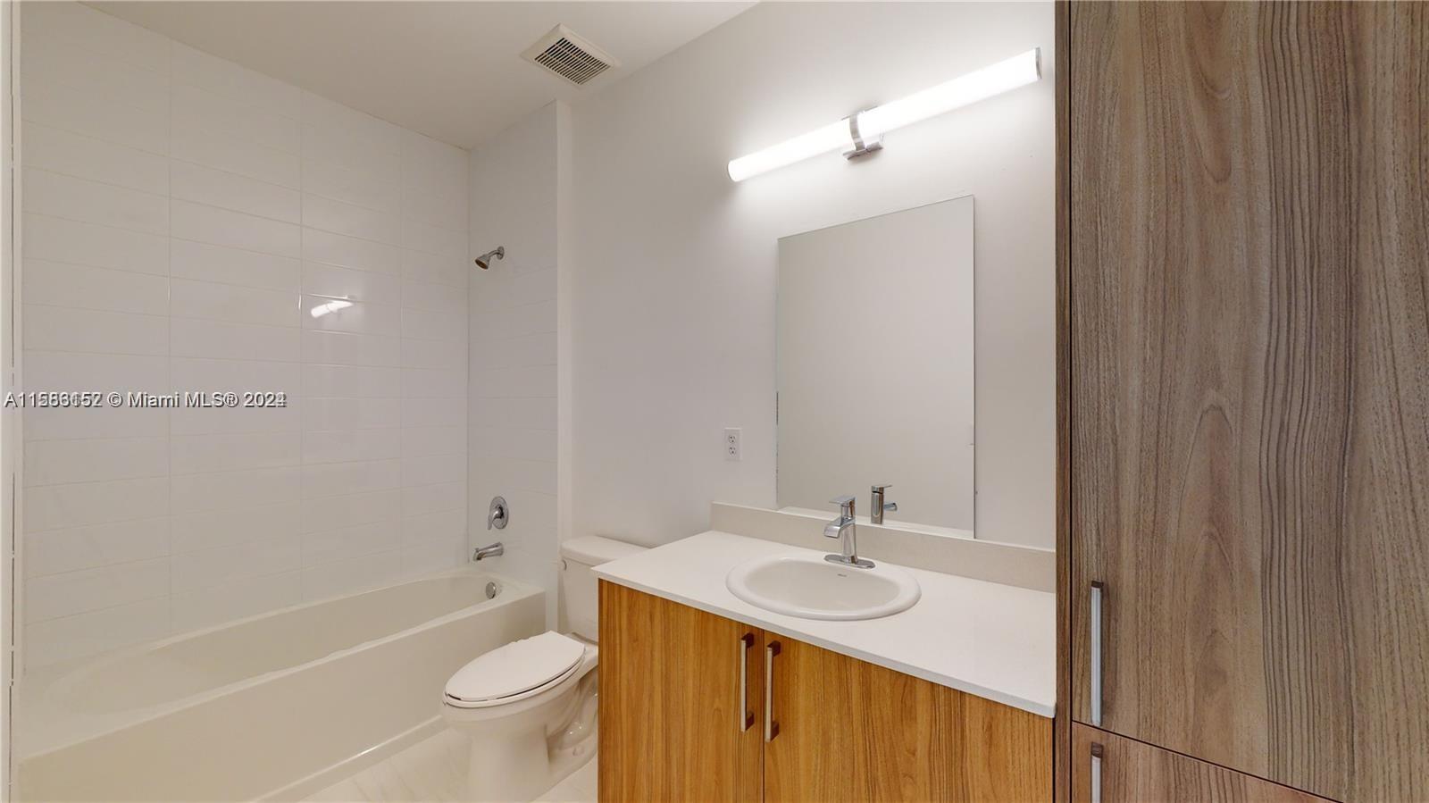 24705 Southwest 129th Avenue, Unit 109 Homestead, FL 33032 - Photo 10 of 22 a bathroom with a sink a toilet and shower