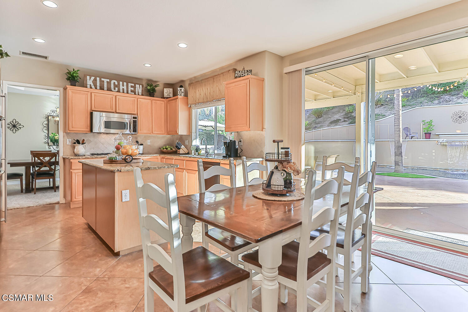 58 Mollison Drive Simi Valley, CA 93065 - Photo 27 of 82 a dining hall with stainless steel appliances granite countertop a stove a sink a dining table and chairs