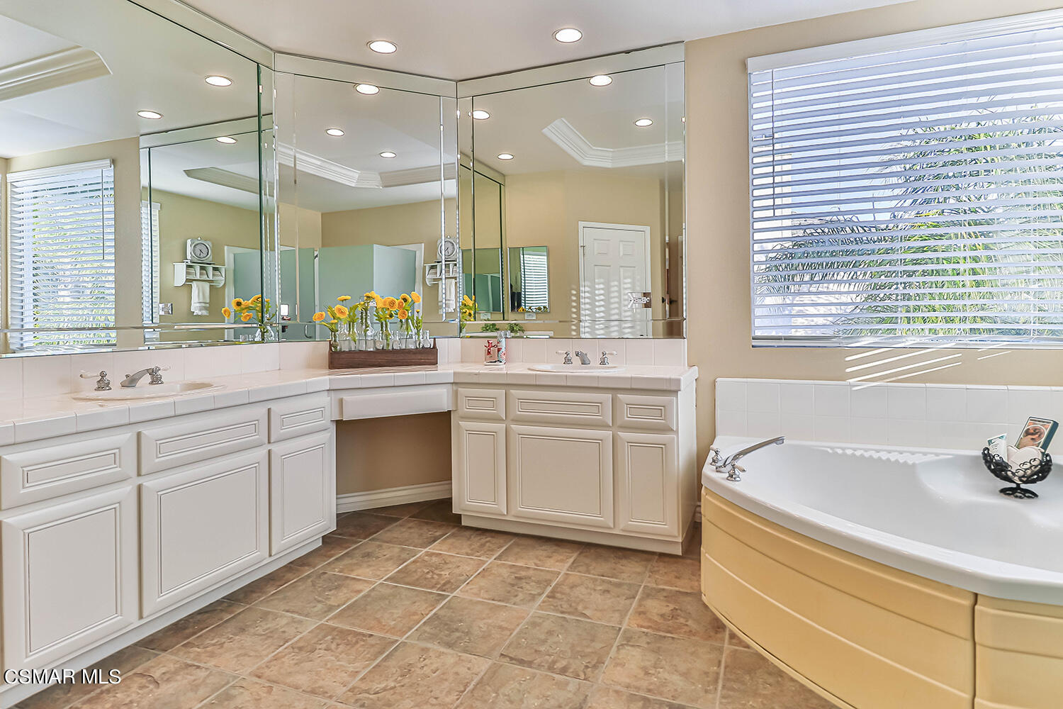 58 Mollison Drive Simi Valley, CA 93065 - Photo 42 of 82 a bathroom with a sink a large mirror and a bathtub next to a window