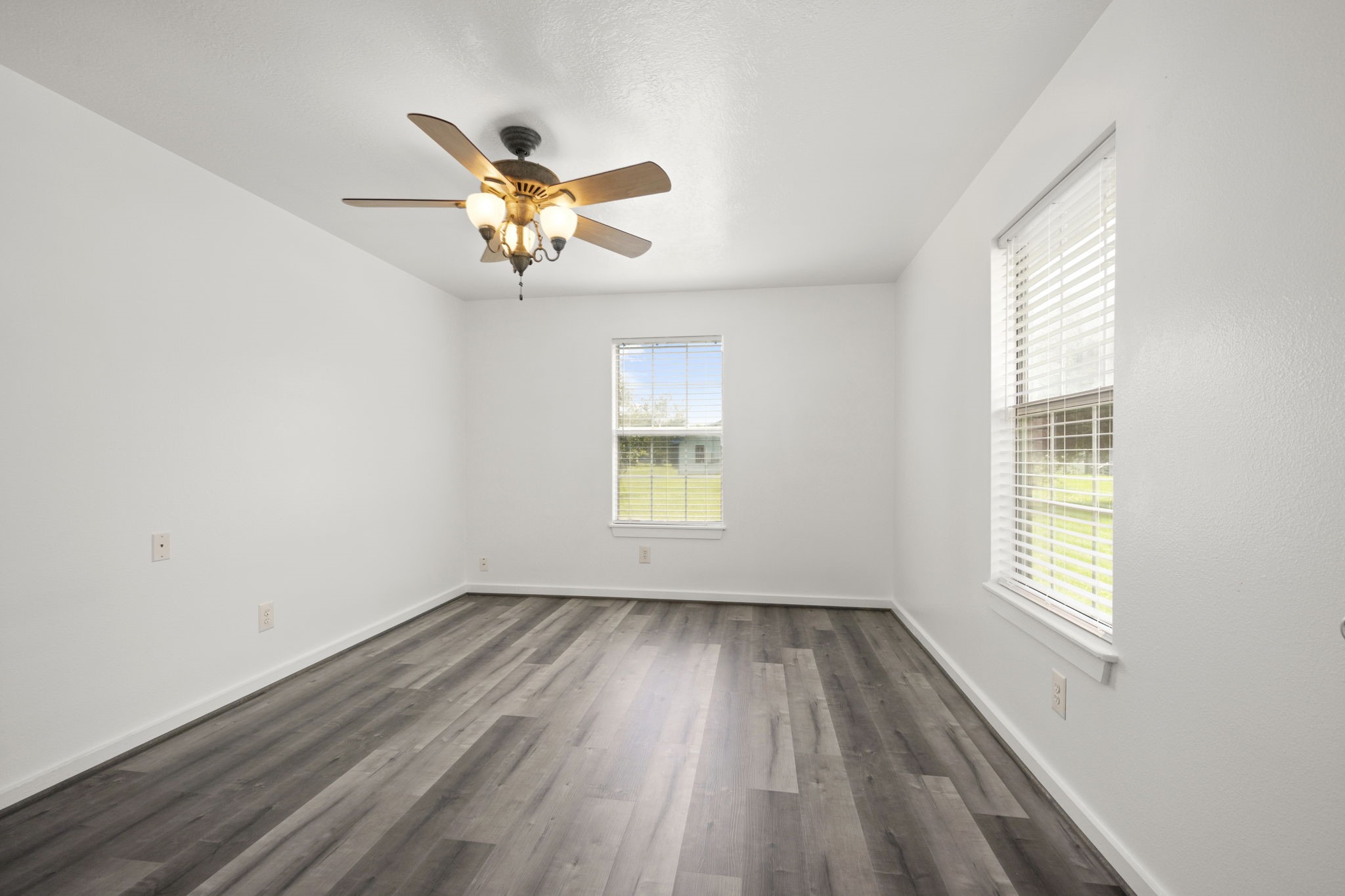 1935 1st Street Hempstead, TX 77445 - Photo 25 of 29 wooden floor in an empty room with a window