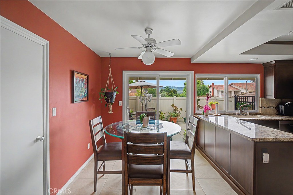 22671 Town Crier Road Calabasas, CA 91302 - Photo 21 of 35 a dining room with furniture a large window and a chandelier