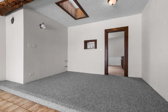 a view of an entryway with wooden floor and door