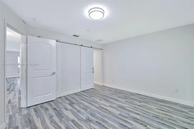 a view of room with wooden floor