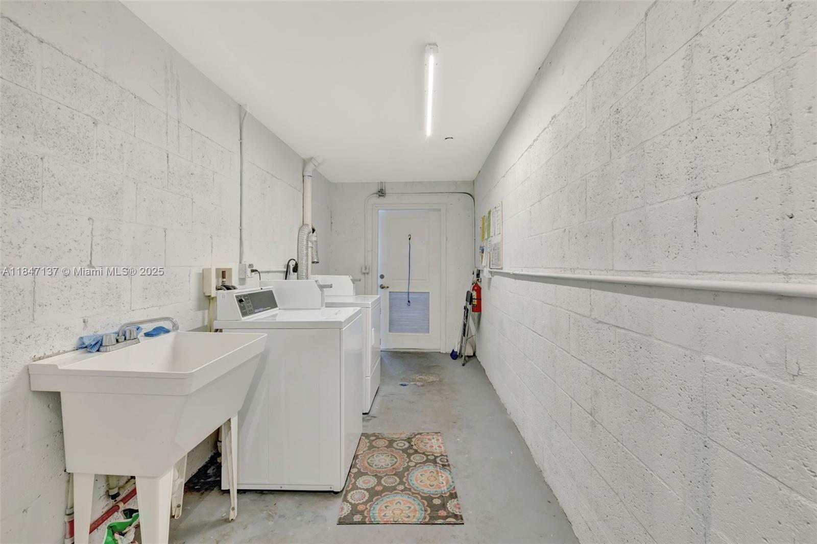 2929 Southeast Ocean Boulevard, Unit F6 Stuart, FL 34996 - Photo 24 of 42 a utility room with a sink dryer and washer