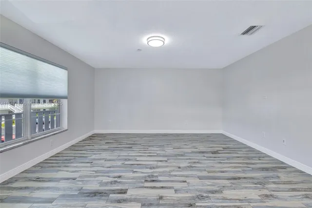 a view of an empty room with glass door