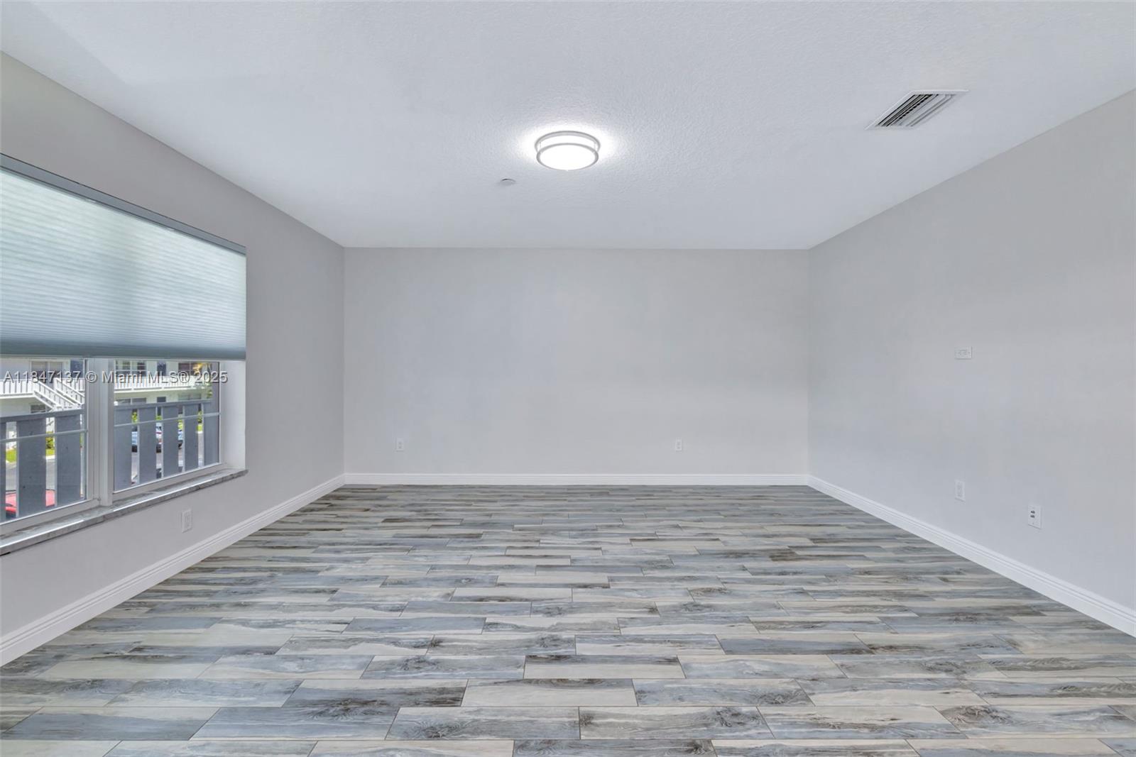 2929 Southeast Ocean Boulevard, Unit F6 Stuart, FL 34996 - Photo 3 of 42 a view of an empty room with glass door