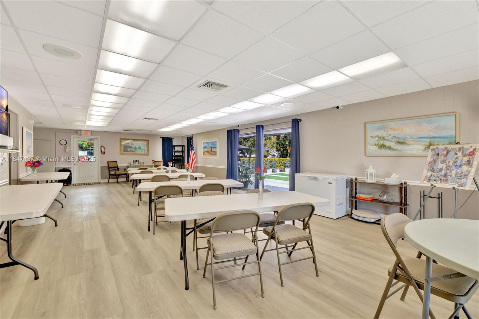 2929 Southeast Ocean Boulevard, Unit F6 Stuart, FL 34996 - Photo 37 of 42 a living room with furniture a wooden floor and a window