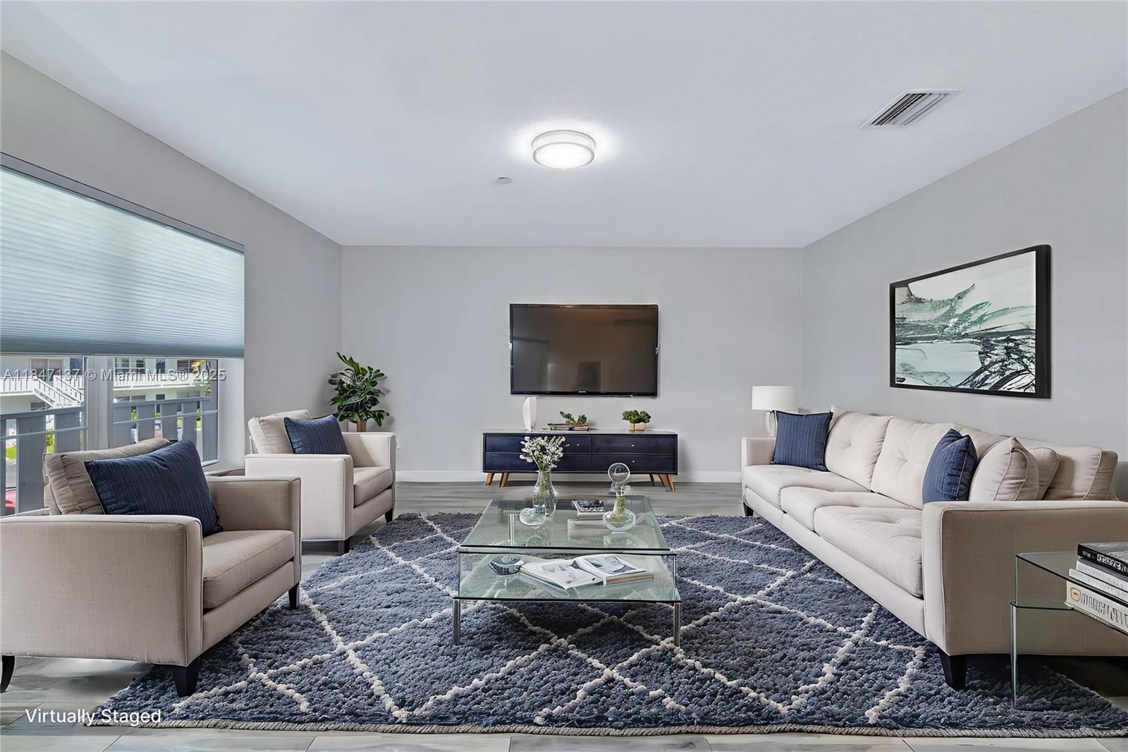 2929 Southeast Ocean Boulevard, Unit F6 Stuart, FL 34996 - Photo 41 of 42 a living room with furniture a rug and a flat screen tv