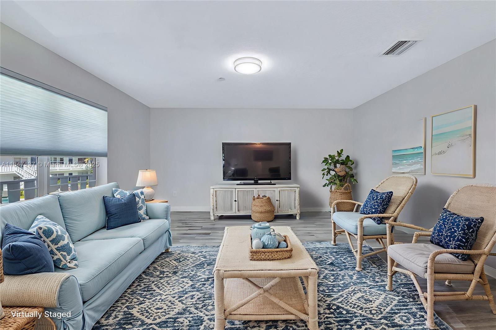 2929 Southeast Ocean Boulevard, Unit F6 Stuart, FL 34996 - Photo 42 of 42 a living room with furniture and a flat screen tv