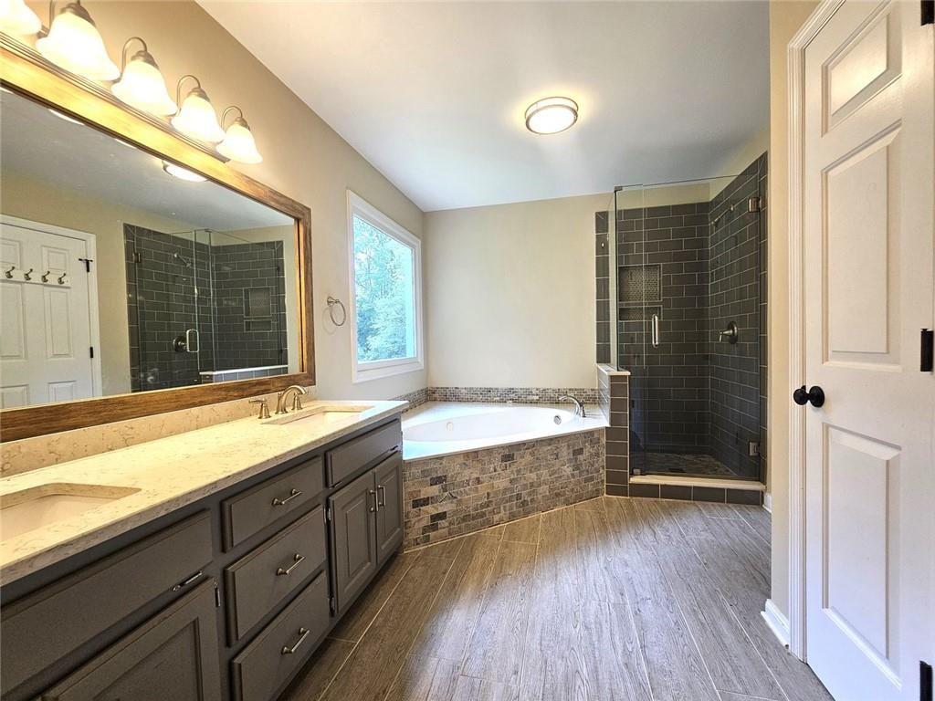 290 Oakmere Road Alpharetta, GA 30009 - Photo 13 of 26 a bathroom with a granite countertop sink mirror bathtub and shower