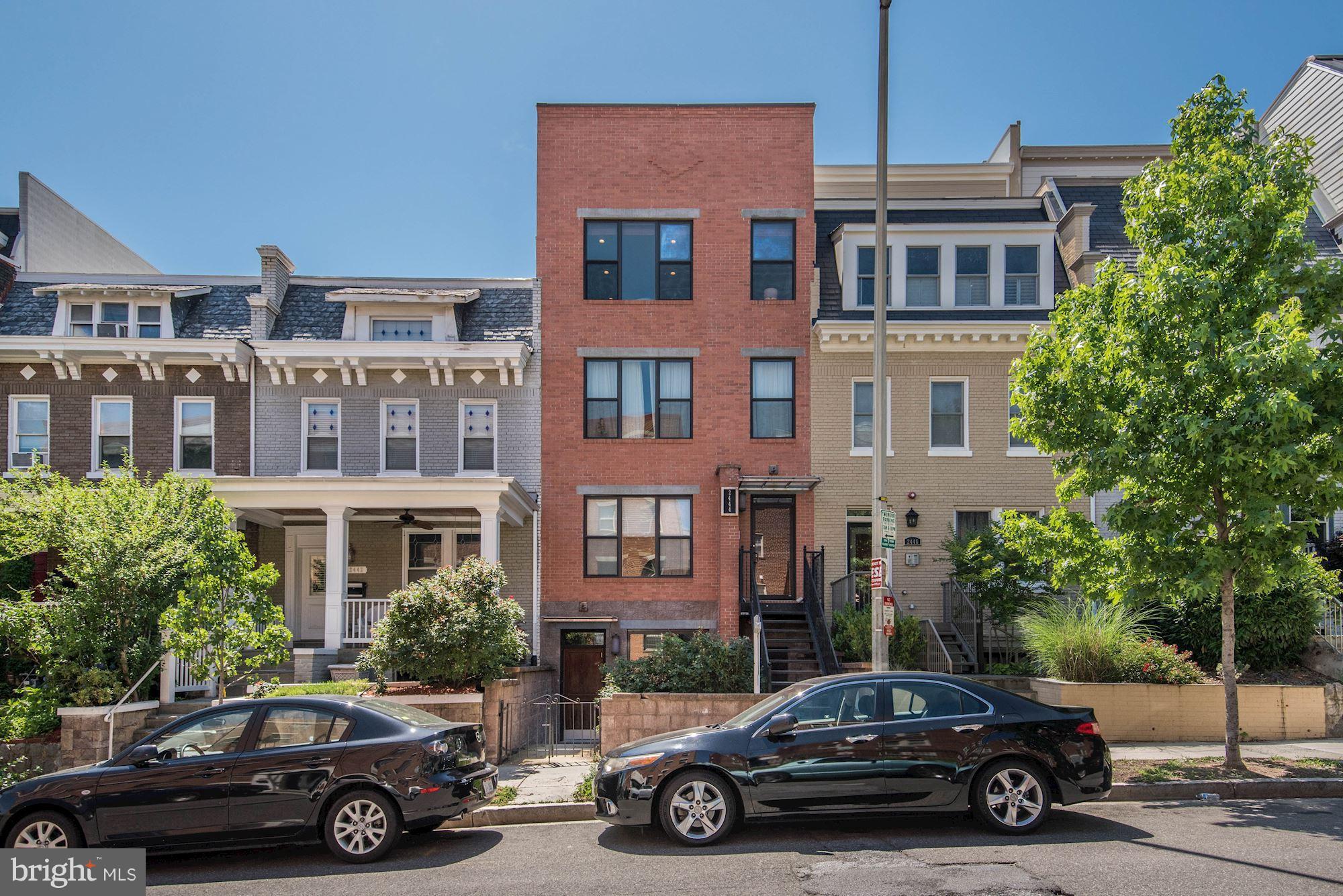a car parked in front of a car parked in front of a house