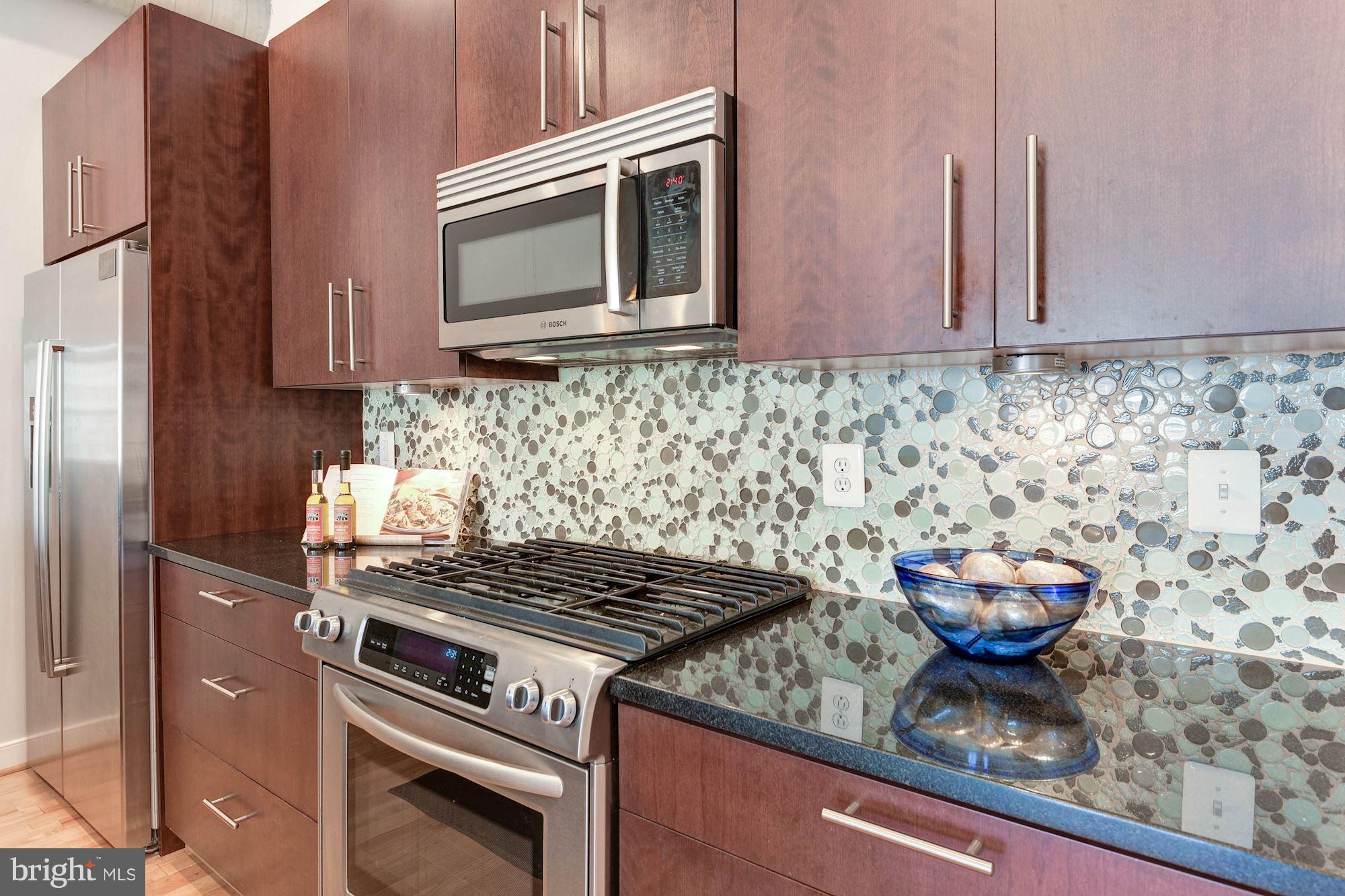 2444 Ontario Road Northwest, Unit 4 Washington, DC 20009 - Photo 12 of 26 a kitchen with stainless steel appliances granite countertop a stove and a microwave