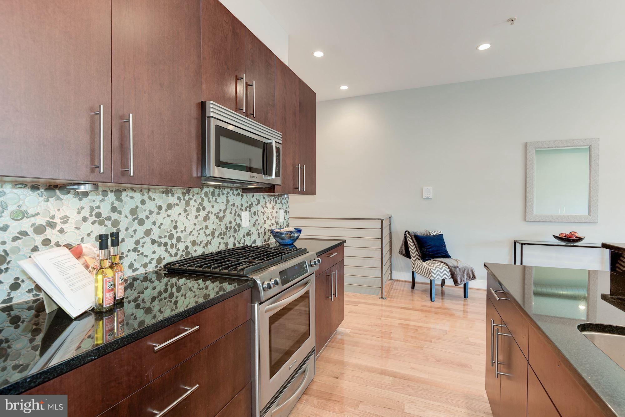 2444 Ontario Road Northwest, Unit 4 Washington, DC 20009 - Photo 13 of 26 a kitchen with stainless steel appliances granite countertop a stove and a sink