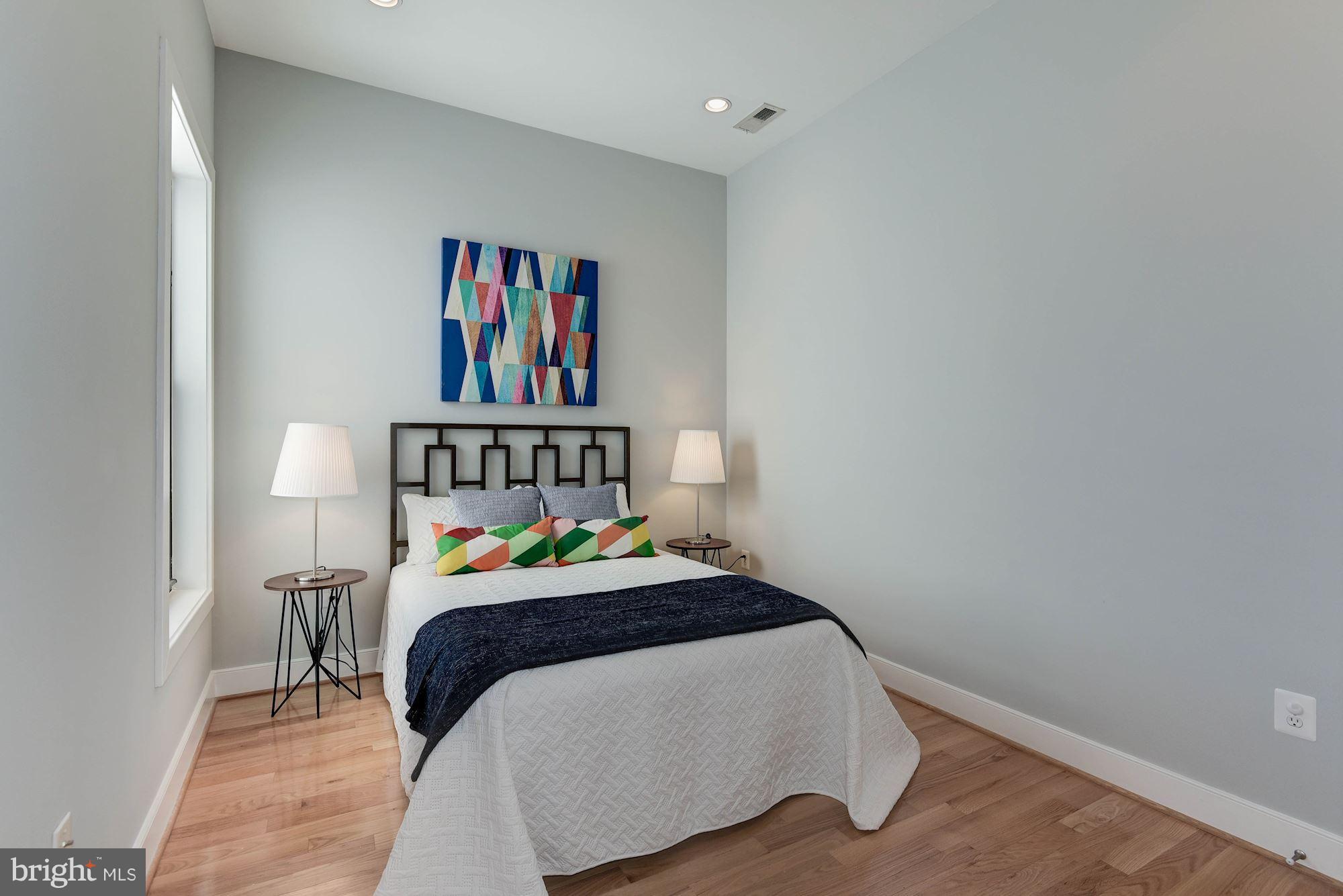 2444 Ontario Road Northwest, Unit 4 Washington, DC 20009 - Photo 19 of 26 a bedroom with a bed and painting on the wall
