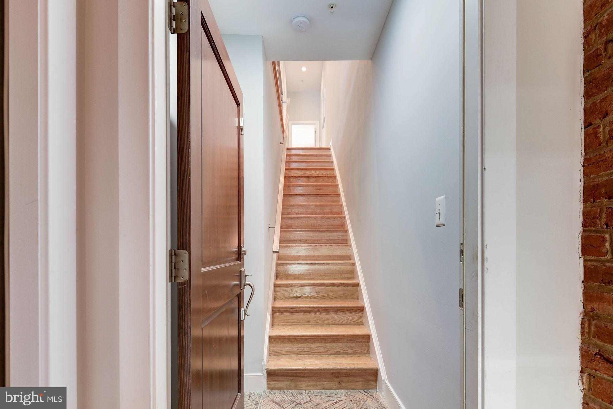 2444 Ontario Road Northwest, Unit 4 Washington, DC 20009 - Photo 3 of 26 a view of a hallway with wooden floor and entryway