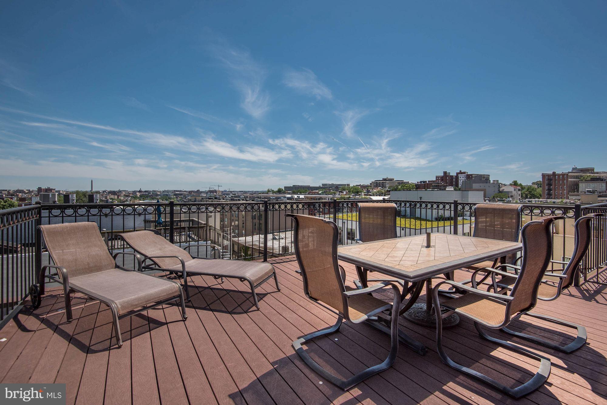 2444 Ontario Road Northwest, Unit 4 Washington, DC 20009 - Photo 25 of 26 a view of a rooftop deck with chairs and wooden floor