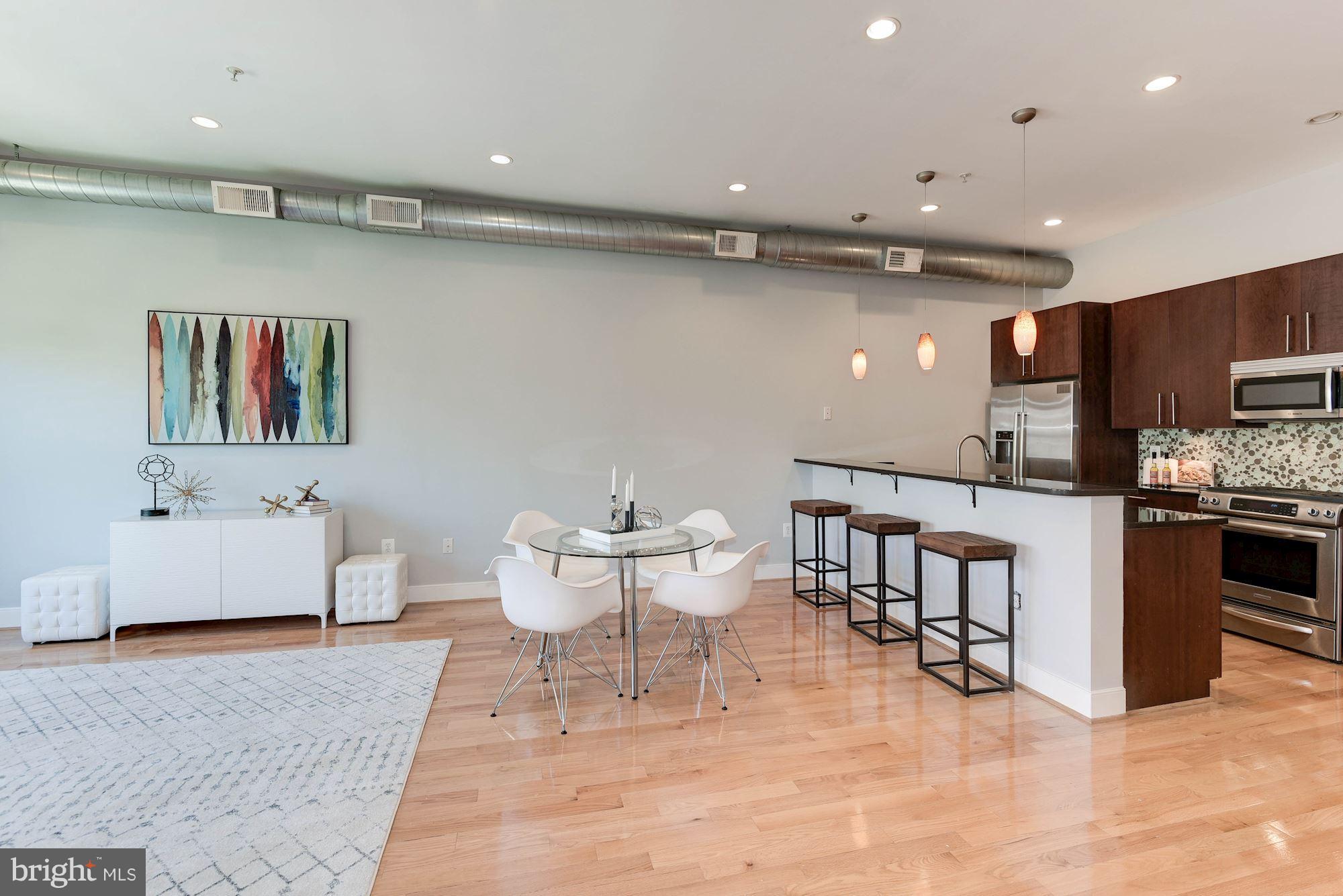 2444 Ontario Road Northwest, Unit 4 Washington, DC 20009 - Photo 6 of 26 a living room with stainless steel appliances furniture a rug and a kitchen view