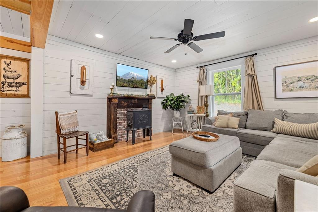 385 Amy's Road Clarkesville, GA 30523 - Photo 12 of 57 a living room with furniture a fireplace and a flat screen tv