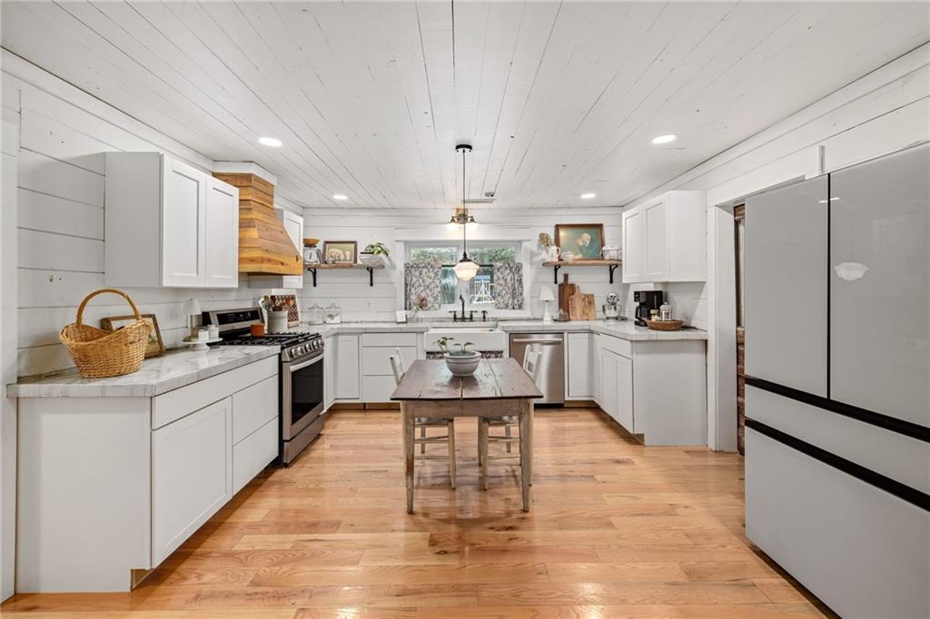 385 Amy's Road Clarkesville, GA 30523 - Photo 16 of 57 a kitchen with stainless steel appliances granite countertop a sink cabinets and a refrigerator