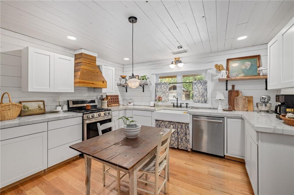 385 Amy's Road Clarkesville, GA 30523 - Photo 17 of 57 a kitchen with a stove a sink a counter space and a window