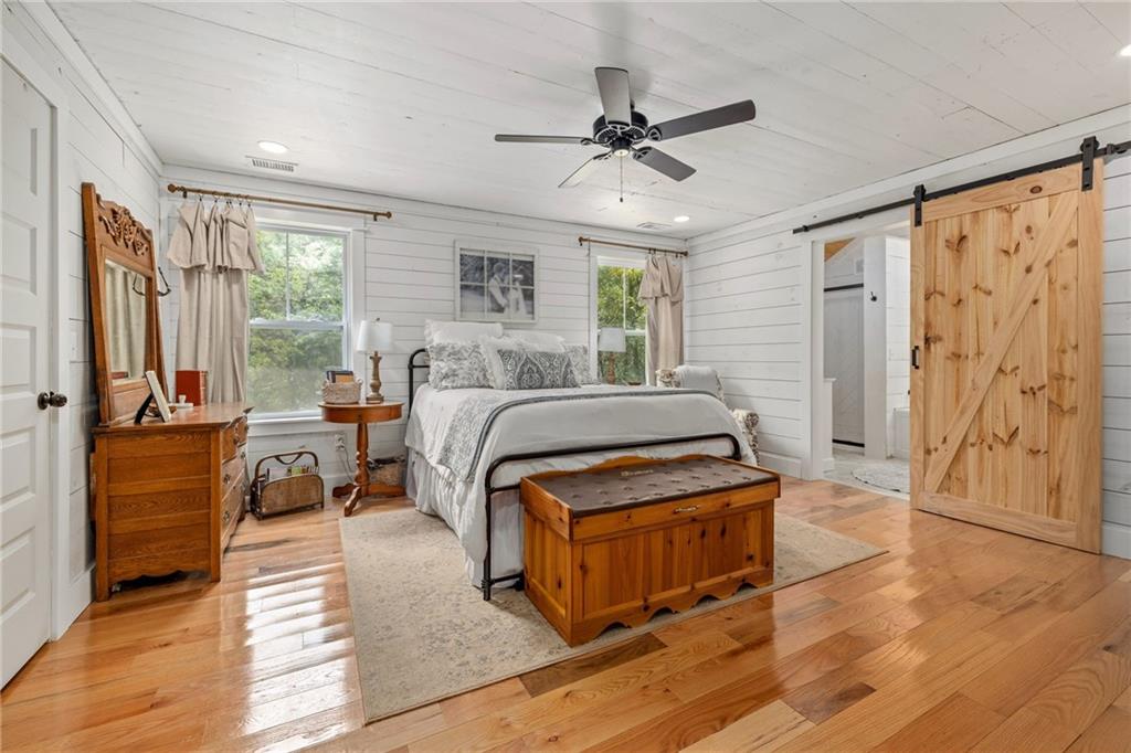 385 Amy's Road Clarkesville, GA 30523 - Photo 19 of 57 a bedroom with a bed and wooden floor