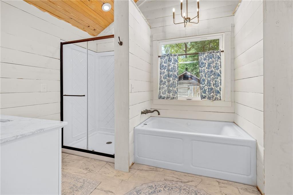385 Amy's Road Clarkesville, GA 30523 - Photo 21 of 57 a bathroom with a tub a window and a shower
