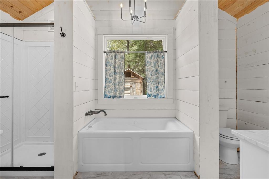 385 Amy's Road Clarkesville, GA 30523 - Photo 22 of 57 a white bath tub sitting next to a window