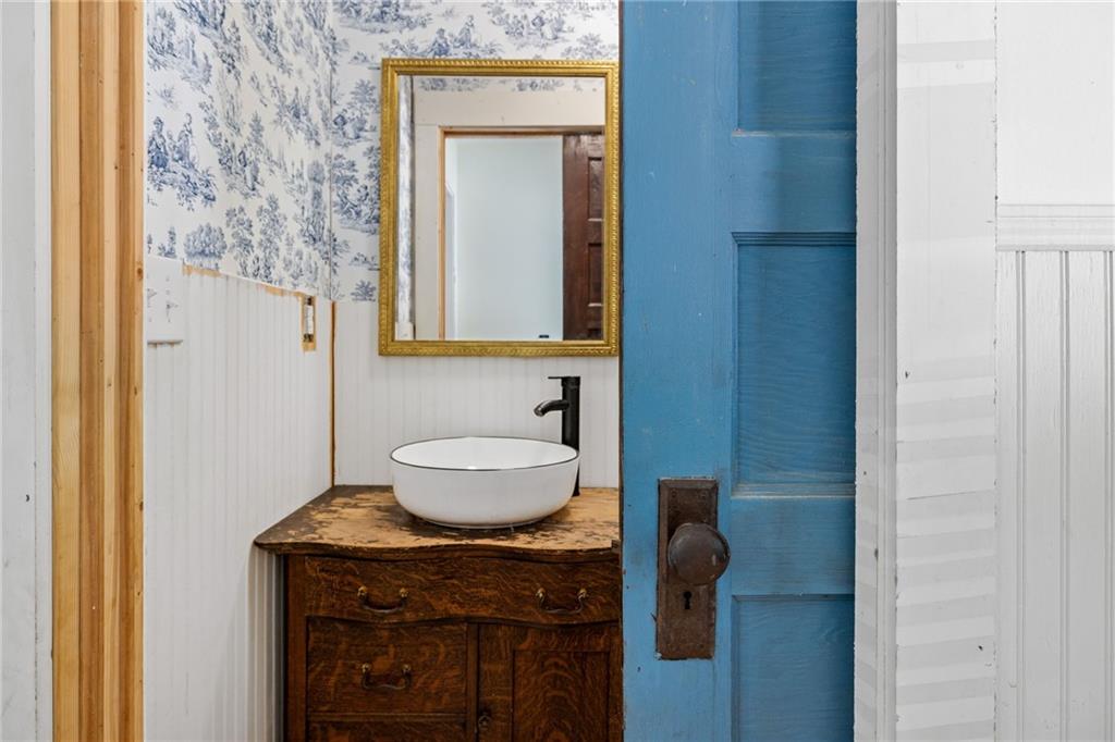 385 Amy's Road Clarkesville, GA 30523 - Photo 28 of 57 a bathroom with a granite countertop sink a toilet and a mirror