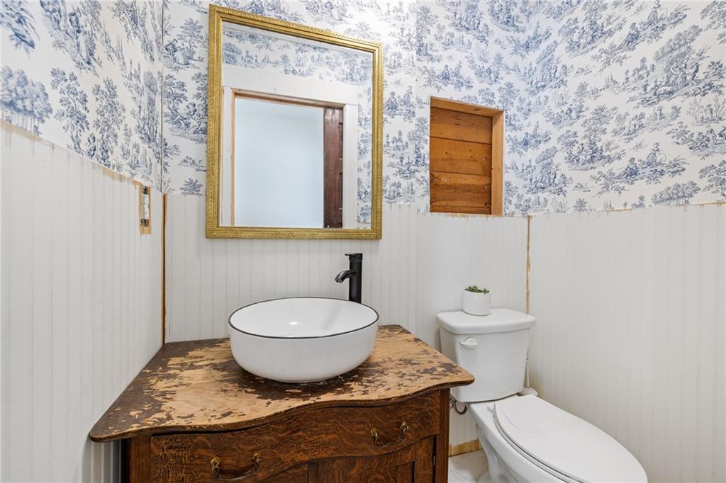 385 Amy's Road Clarkesville, GA 30523 - Photo 29 of 57 a bathroom with a granite countertop toilet sink and mirror