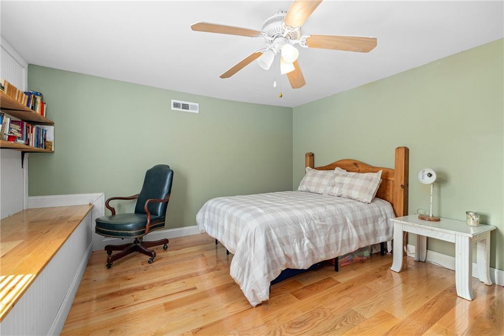 385 Amy's Road Clarkesville, GA 30523 - Photo 31 of 57 a bedroom with a bed a chair and a potted plant on the dresser