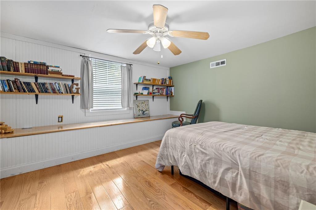 385 Amy's Road Clarkesville, GA 30523 - Photo 32 of 57 a bedroom with a bed and a chandelier