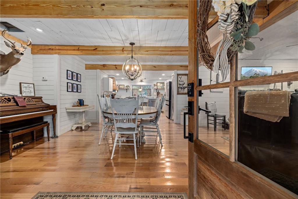 385 Amy's Road Clarkesville, GA 30523 - Photo 9 of 57 a dining room with furniture a chandelier and wooden floor