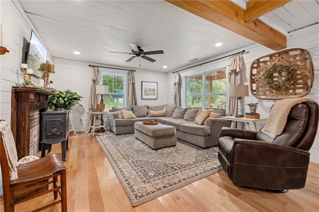 385 Amy's Road Clarkesville, GA 30523 - Photo 10 of 57 a living room with furniture a fireplace and a floor to ceiling window