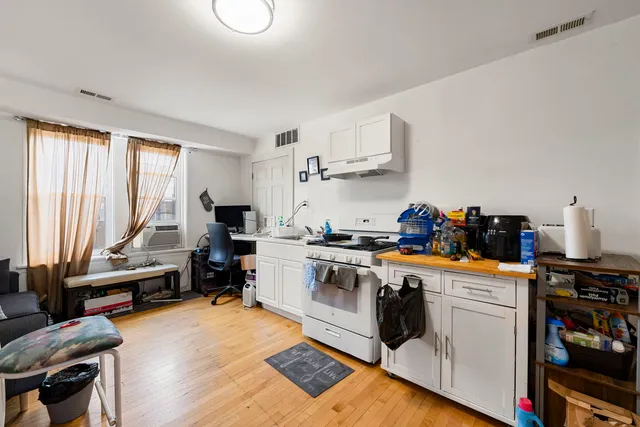 a kitchen with a stove a sink and a refrigerator