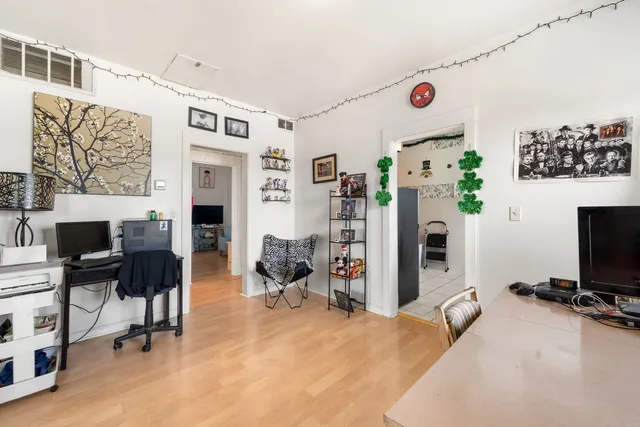 a view of a livingroom with furniture and a flat screen tv