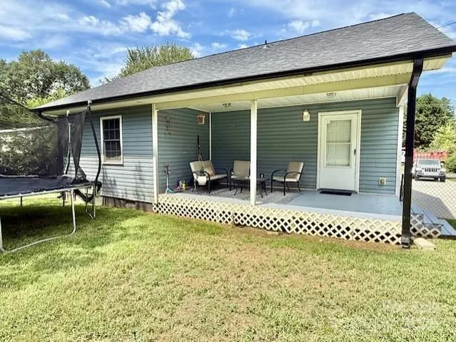 a backyard of a house with table and chairs