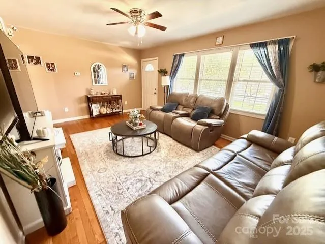 a living room with furniture rug and a window