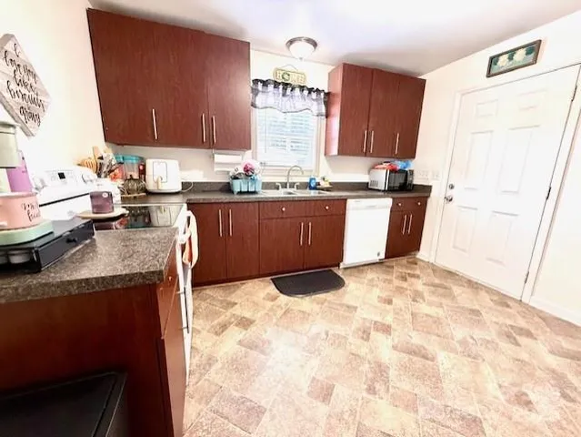 a kitchen with a sink stove and refrigerator