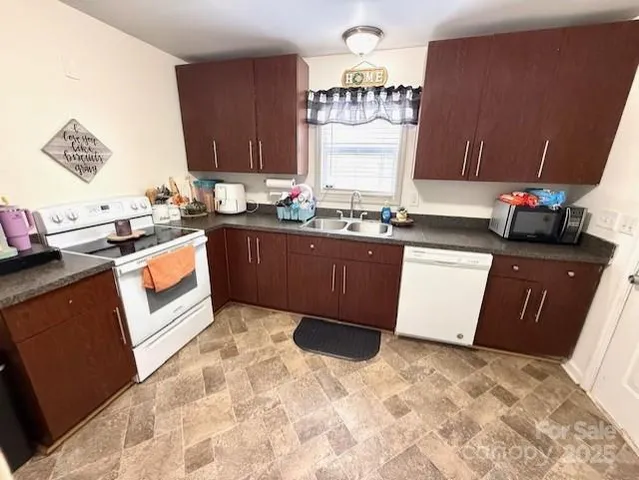 a kitchen with stainless steel appliances granite countertop a refrigerator and a stove