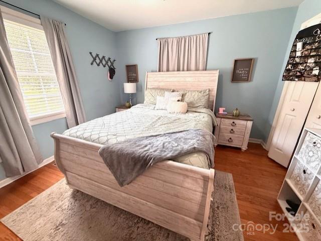 114 Yates Street Dallas, NC 28034 - Photo 34 of 41 a bedroom with a bed and wooden floor