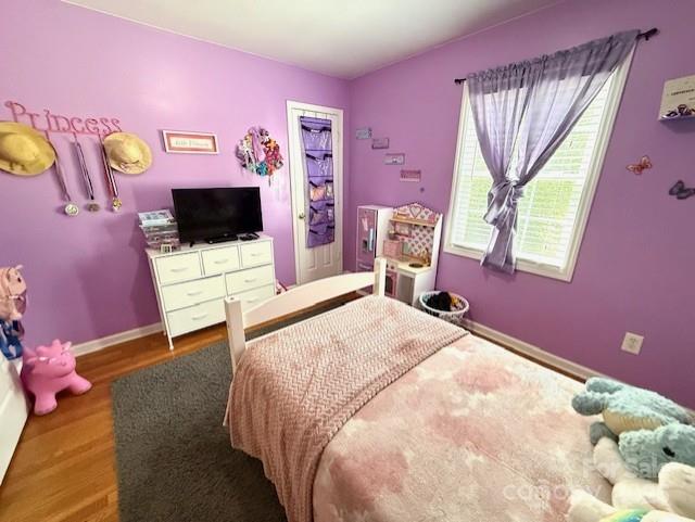 114 Yates Street Dallas, NC 28034 - Photo 37 of 41 a bedroom with a bed and a flat screen tv on dresser